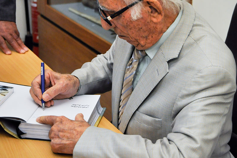 Issa Omidvar, the Iranian world traveller giving signature to the fans  